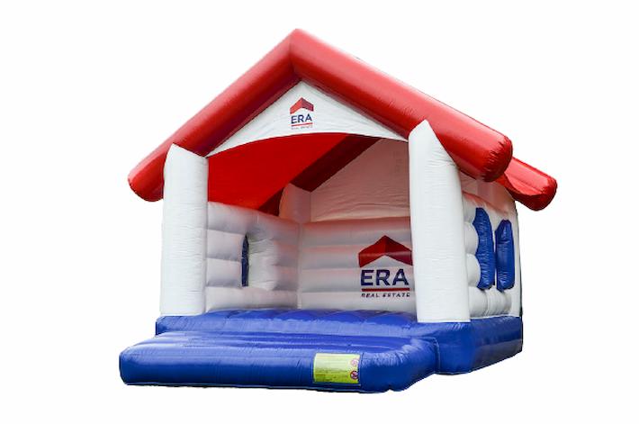 Opblaasbaar springkussen in de vorm van een huisje met de huisstijl van ERA op maat gemaakt